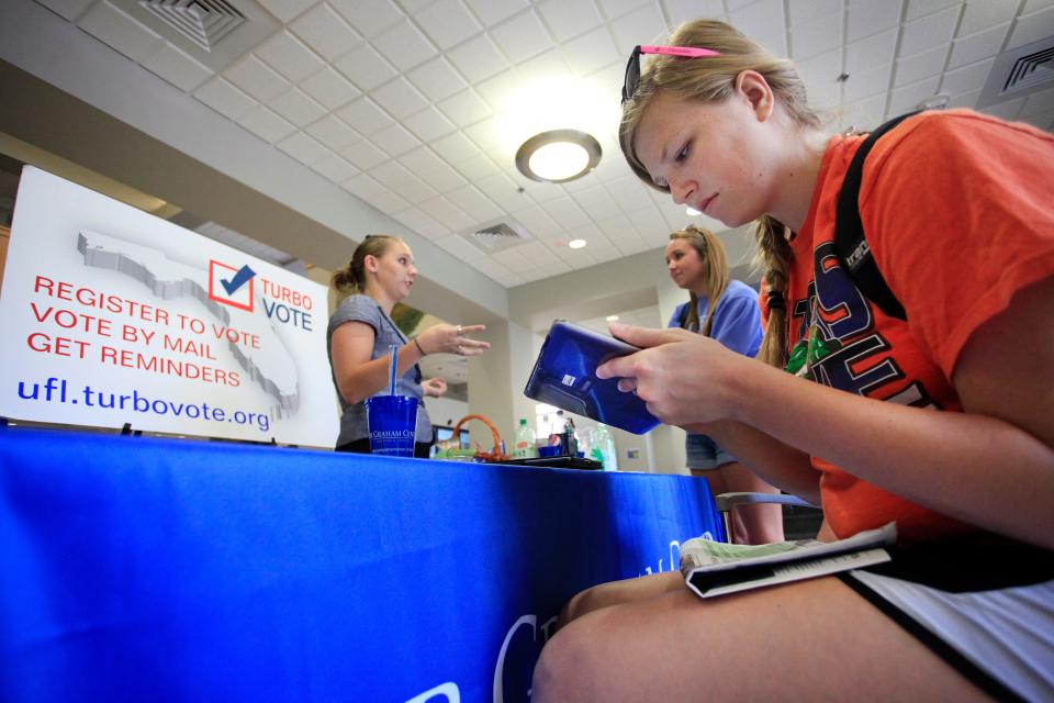 Students register to vote at an event held at the University of Florida.