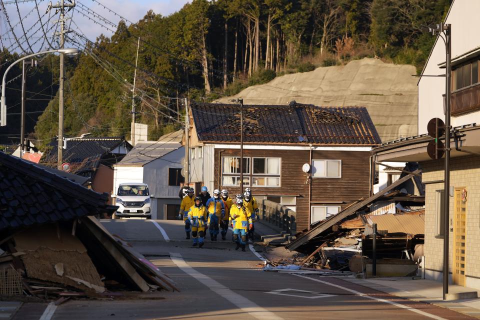 Rescue workers search collapsed houses damaged by powerful earthquake in Anamizu in the Noto peninsula facing the Sea of Japan, northwest of Tokyo, Thursday, Jan. 4, 2024. More soldiers have been ordered to bolster the rescue operations Thursday, providing those in need with drinking water, hot meals and setting up bathing facilities after a magnitude 7.6 quake hit Ishikawa Prefecture and nearby regions Monday. (AP Photo/Hiro Komae)