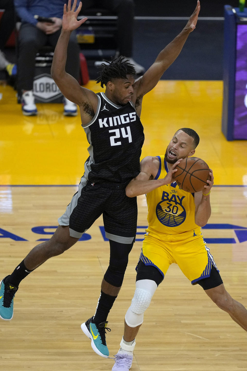 Golden State Warriors guard Stephen Curry (30) reacts as he is fouled by Sacramento Kings guard Buddy Hield (24) during the first half of an NBA basketball game on Sunday, April 25, 2021, in San Francisco. (AP Photo/Tony Avelar)