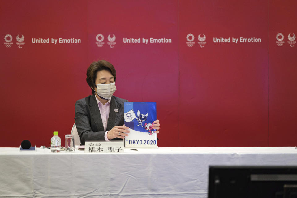 Seiko Hashimoto, the head of the Tokyo Olympics (Tokyo 2020) organizing committee, holds a Tokyo 2020 folder during a Tokyo 2020 executive board meeting Monday, April 26, 2021 in Tokyo, Japan. (Nicolas Datiche/Pool Photo via AP)