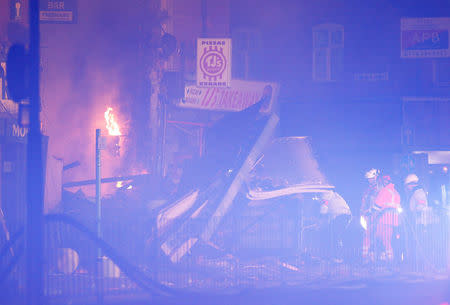 Members of the emergency services work at the site of an explosion which destroyed a convenience store and a home in Leicester, Britain, February 25, 2018. REUTERS/Darren Staples