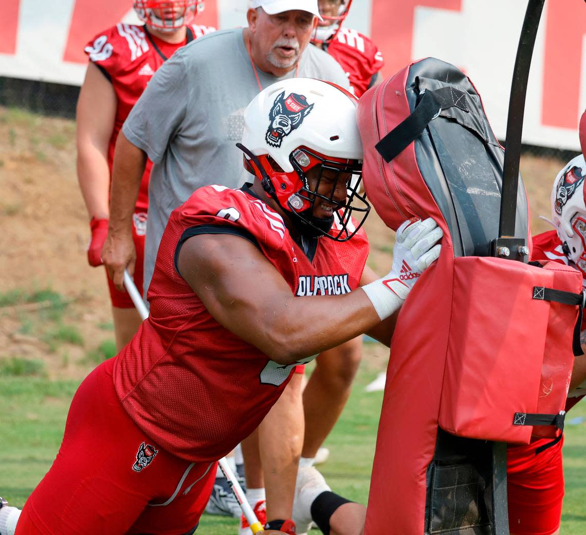 N.C. State defensive end Savion Jackson (9) hits the pads during the Wolfpack’s first fall practice in Raleigh, N.C., Wednesday, August 2, 2023. Ethan Hyman/ehyman@newsobserver.com