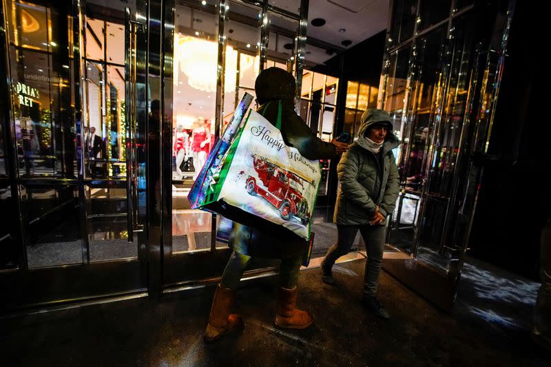 FILE PHOTO: People visit a retail store during the holiday season in New York