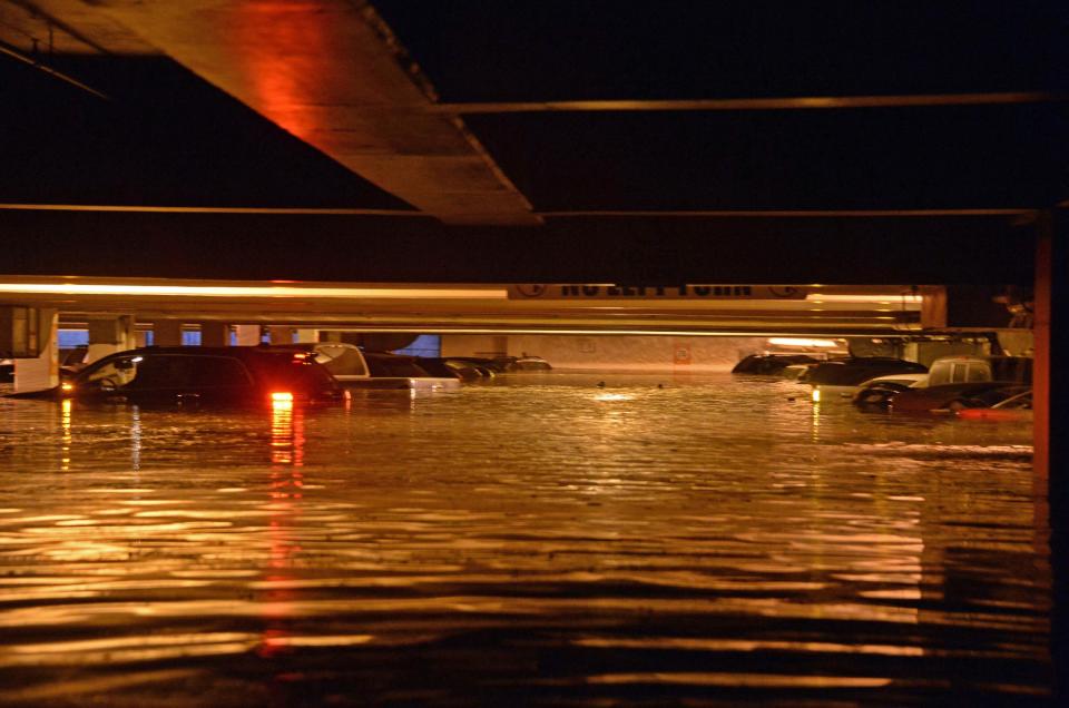 Vehicles are inundated in several feet of water in a parking structure on the UCLA campus after flooding from a broken 30-inch water main under nearby Sunset Boulevard inundated a large area of the campus in the Westwood section of Los Angeles, Tuesday, July 29, 2014. The 30-inch (75-centimeter) 93-year-old pipe that broke made a raging river of the street and sent millions of gallons (liters) of water across the school's athletic facilities, including the famed floor of Pauley Pavilion, the neighboring Wooden Center and the Los Angeles Tennis Center, and a pair of parking structures that took the brunt of the damage. (AP Photo/Mike Meadows)