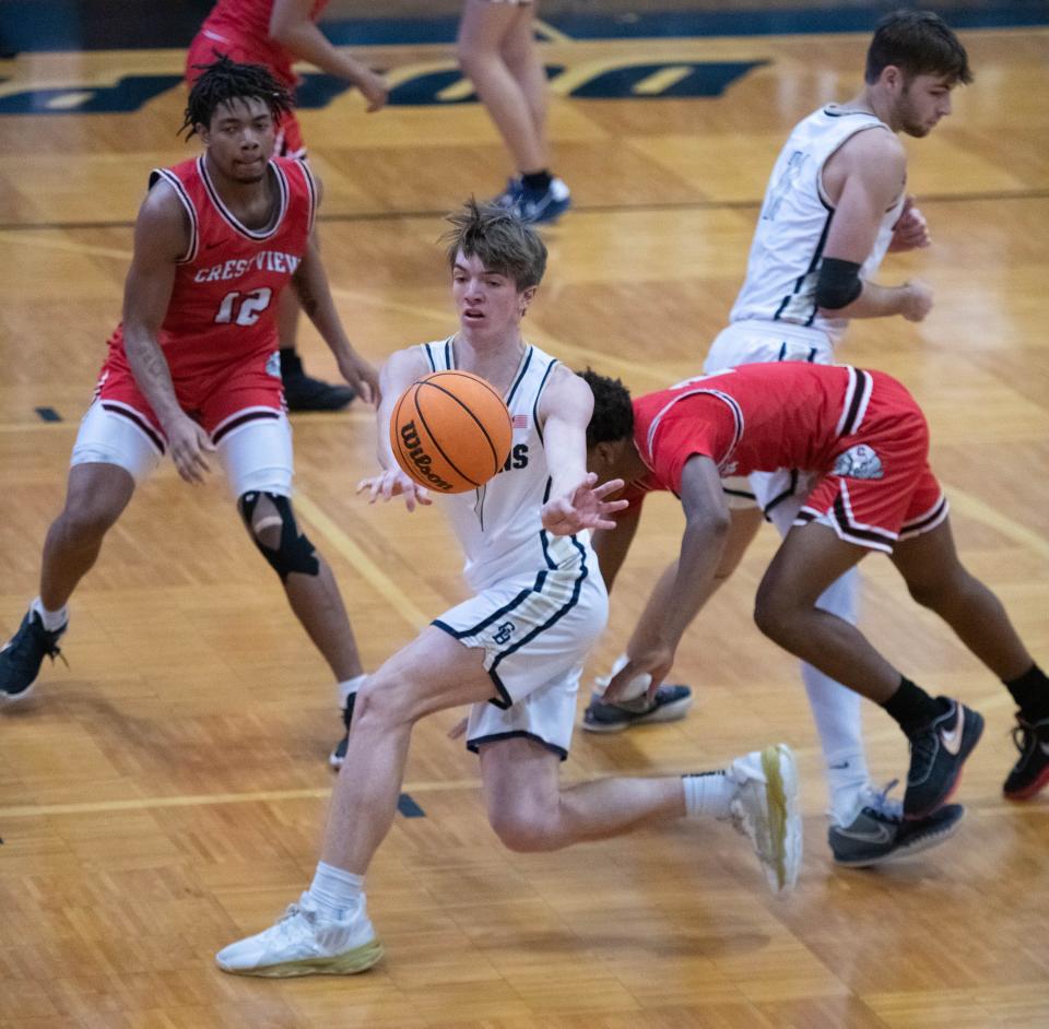 Max Schneidt (1) passes the ball during the Crestview vs Gulf Breeze boys basketball game at Gulf Breeze High School on Tuesday, Dec. 20, 2022.