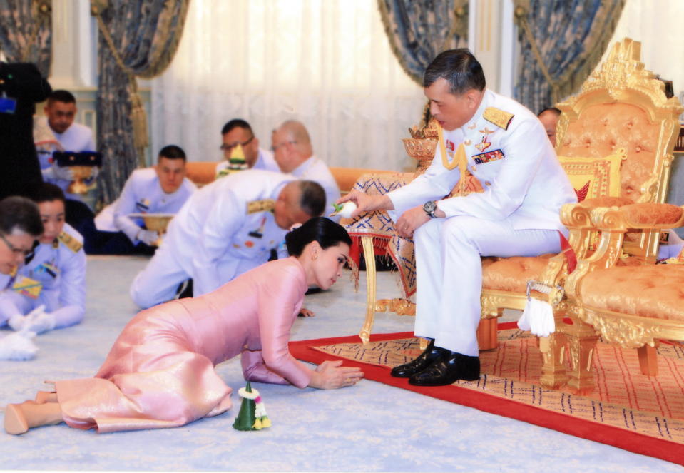 The Thai king Maha Vajiralongkorn pours wedding water on to Queen Suthida during a royal marriage registration ceremony at the Amphorn Sathan Residential Hall.