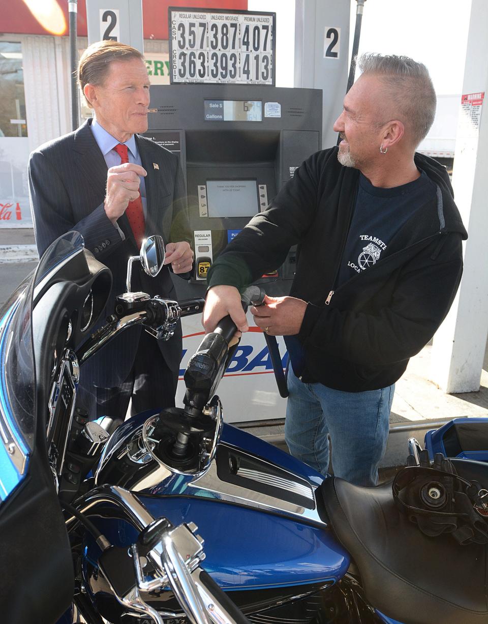 U.S. Sen. Richard Blumenthal, a Connecticut Democrat, talks with Bill Passero, 52, of North Franklin, Conn., while he pumps premium gas for $4.19 a gallon in to his motorcycle at Global gas station in Norwichtown, Conn. He said of Blumenthal's proposal for a temporary end to the 18.4 cent federal gas tax "We pay too much in taxes now. Every little bit helps."