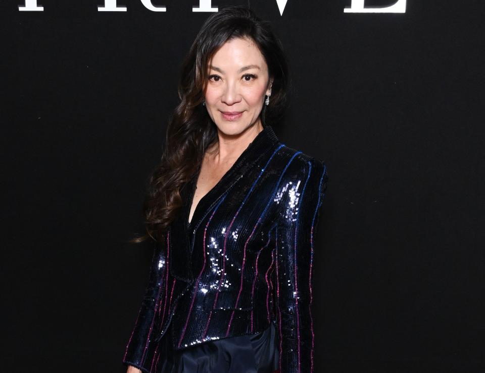 A close-up of Michelle in a long-sleeved, sparkly jacket with vertical lines