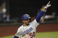 Los Angeles Dodgers' Mookie Betts celebrates a home run against the Tampa Bay Rays during the sixth inning in Game 1 of the baseball World Series Tuesday, Oct. 20, 2020, in Arlington, Texas. (AP Photo/Eric Gay)
