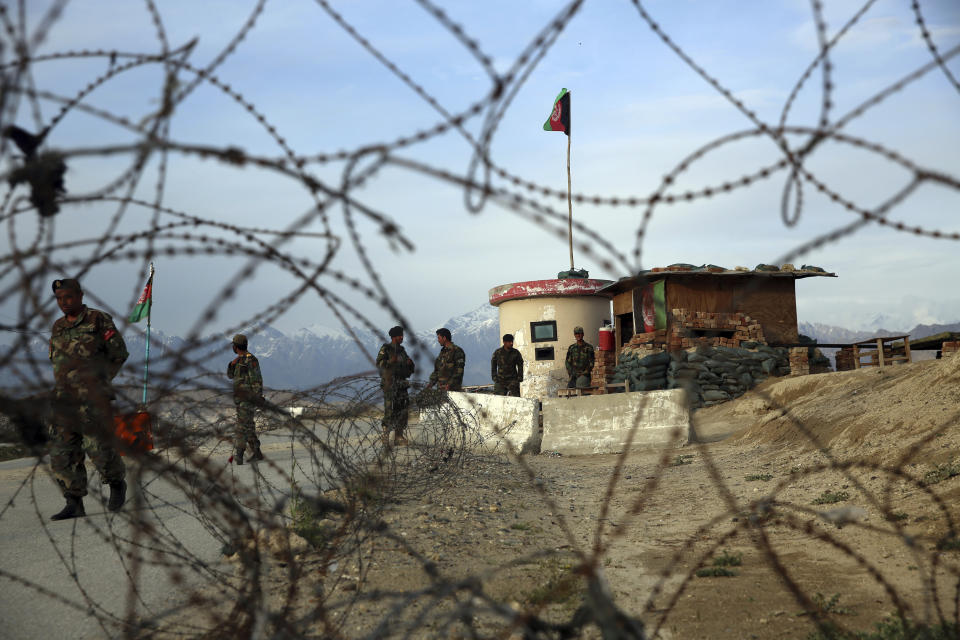 Afghan National Army soldiers stand guard at a checkpoint near the Bagram base in northern Kabul, Afghanistan, Wednesday, April 8, 2020. An Afghan official said Wednesday that the country has released 100 Taliban prisoners from Bagram, claiming they are part of 5,000 detainees who are to be freed under a deal between insurgents and U.S. But the Taliban says they have yet to verify those released were on the list they had handed over to Washington during negotiations. (AP Photo/Rahmat Gul)