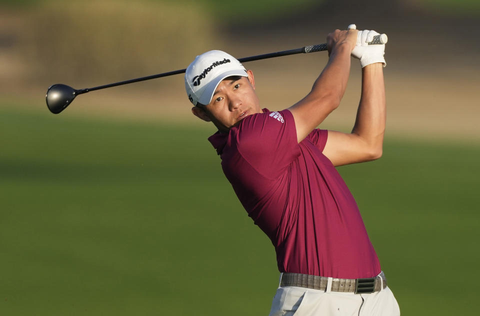 Colin Morikawa of the U.S. plays a shot on the 10th hole during first round of the Dubai Desert Classic golf tournament in Dubai, United Arab Emirates, Thursday, Jan. 27, 2022. (AP Photo/Kamran Jebreili)