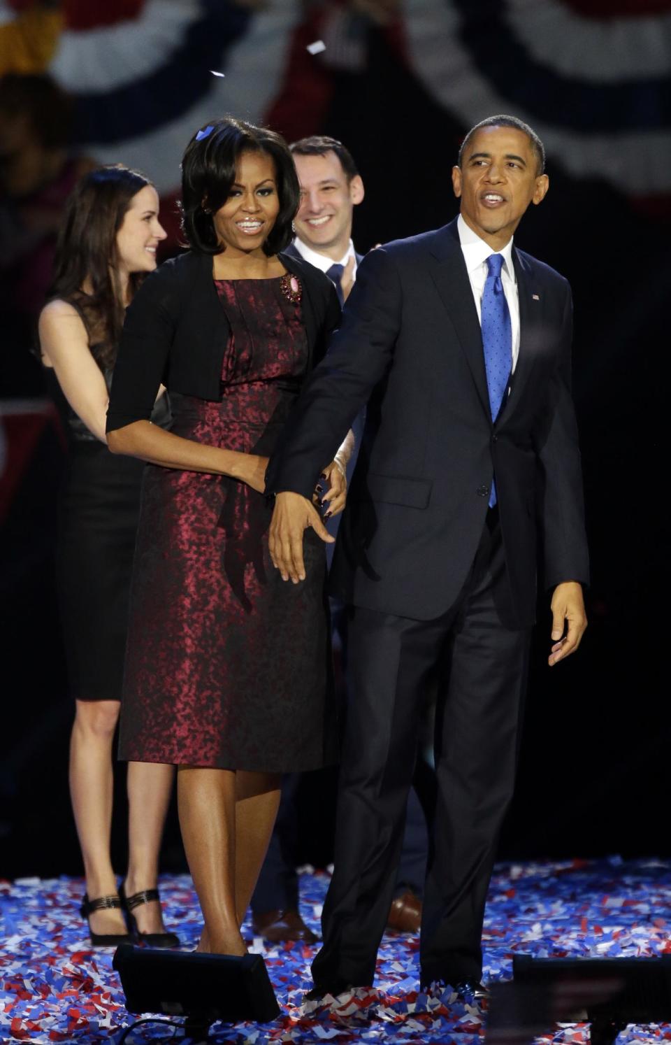 First lady Michelle Obama and President Barack Obama acknowledge their supporters at his election night party Wednesday, Nov. 7, 2012, in Chicago. President Obama defeated Republican challenger former Massachusetts Gov. Mitt Romney. (AP Photo/Pablo Martinez Monsivais)