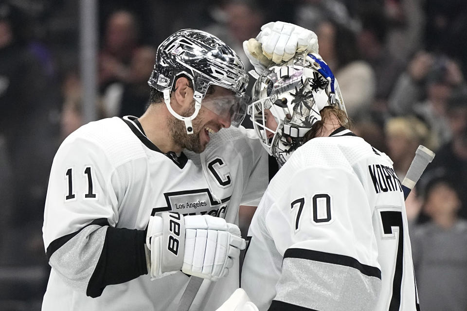 Los Angeles Kings center Anze Kopitar, left, and goaltender Joonas Korpisalo congratulate each other after the Kings defeated the Vancouver Canucks in an NHL hockey game Monday, April 10, 2023, in Los Angeles. (AP Photo/Mark J. Terrill)