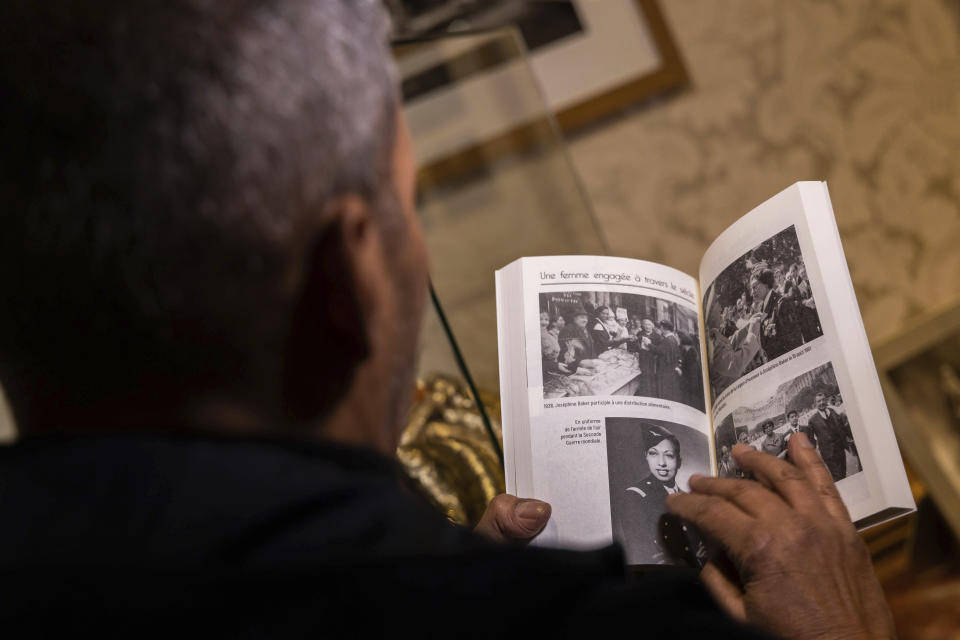 Josephine Baker' son Brian Bouillon-Baker shows a book on Josephine Baker, in the Chateau des Milandes, in Castelnaud-la-Chapelle, central France, Thursday, Nov. 11, 2021. France is inducting Josephine Baker – Missouri-born cabaret dancer, French Resistance fighter and civil rights leader – into its Pantheon, the first Black woman honored in the final resting place of France's most revered luminaries. (AP Photo/Yohan Bonnet)