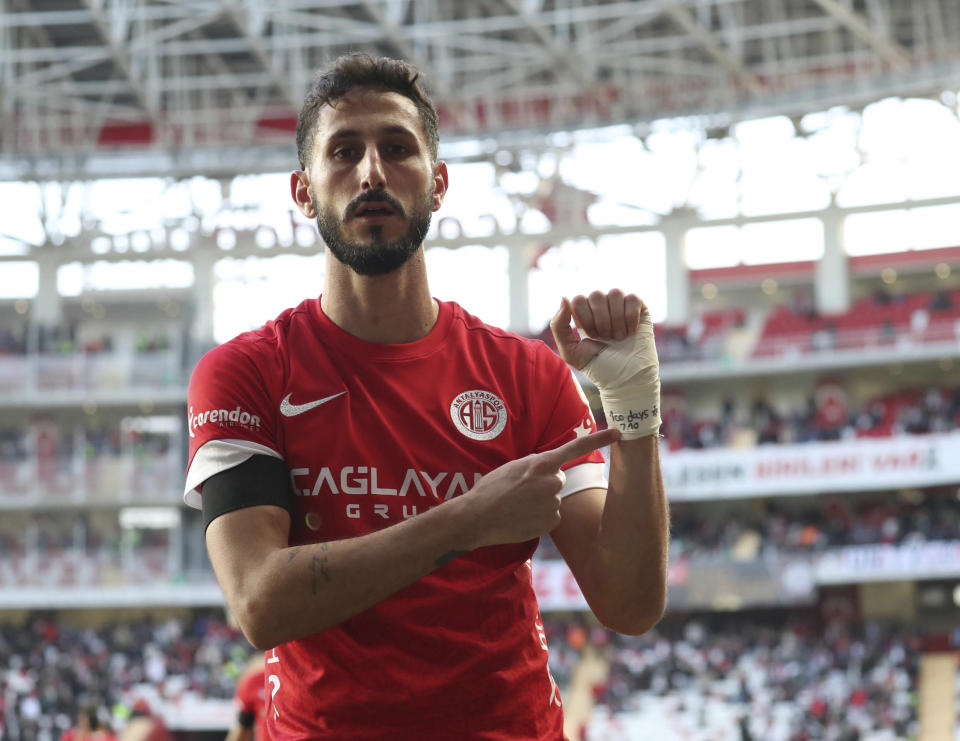 Antalyaspor's Sagiv Jehezkel points a message in his bandage that reads: "100 days. 7.10" as he celebrates after scoring his side's first goal during a Turkish Super Lig soccer match between Antalyaspor and Trabzonspor in Antalya, southern Turkey, Sunday, Jan. 14, 2024. Turkish authorities have detained Turkish top-flight soccer club Antalyaspor's Israeli player Sagiv Jehezkel for questioning after he displayed solidarity with people held hostage by the Hamas militant organization during a league game. (Adem Akalan/DHA via AP)