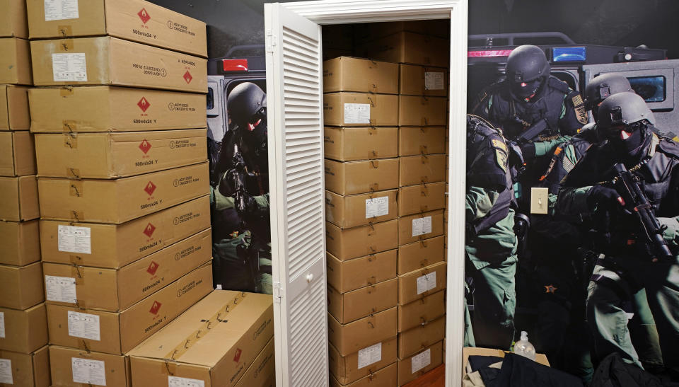 Cases of hand sanitizer are stacked on the retail floor and stored in a changing room for fitting bulletproof vests at the Body Armor Outlet store, Wednesday, Dec. 9, 2020, in Salem, N.H. An Associated Press analysis shows states spent more than $7 billion this spring buying personal protective equipment like masks, gloves and gowns as well as vital medical devices like ventilators. Bellia's store rapidly evolved into one of the nation's 20 largest suppliers of personal protective equipment to states this past spring. (AP Photo/Charles Krupa)