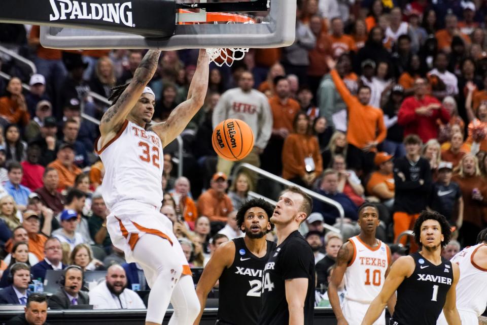 Texas forward Christian Bishop dunks during the first half of Friday night's 83-71 win over Xavier in the Sweet 16 of the NCAA Tournament. The second-seeded Longhorns will play Miami, which knocked off No. 1 seed Houston earlier Friday night, in Sunday's Elite Eight.