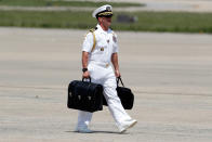 <p>A U.S. Navy military aide carries the “president’s emergency satchel,” also know as “the football,” with the nuclear launch codes, as he walks to Air Force One at Andrews Air Force Base, Md., Friday, May 19, 2017. President Donald Trump is departing for his first overseas trip. (Photo: Alex Brandon/AP) </p>