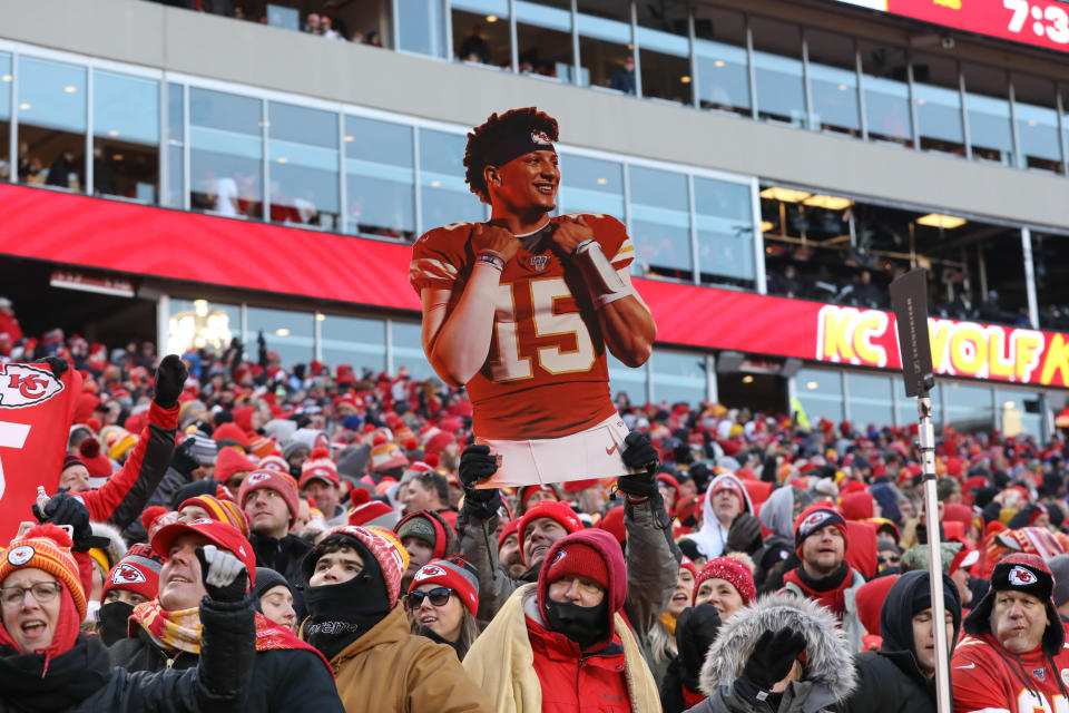 Kansas City Chiefs fans hold up a large cutout of quarterback Patrick Mahomes.
