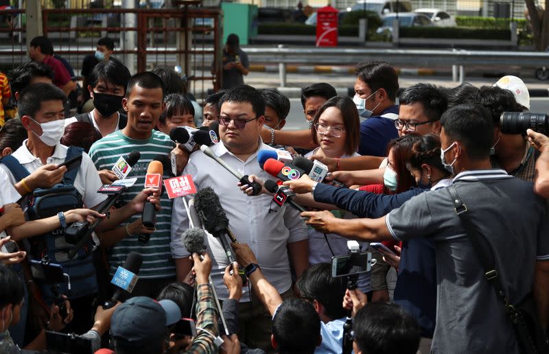 Protest leaders arrive to report themselves at a police station in Bangkok