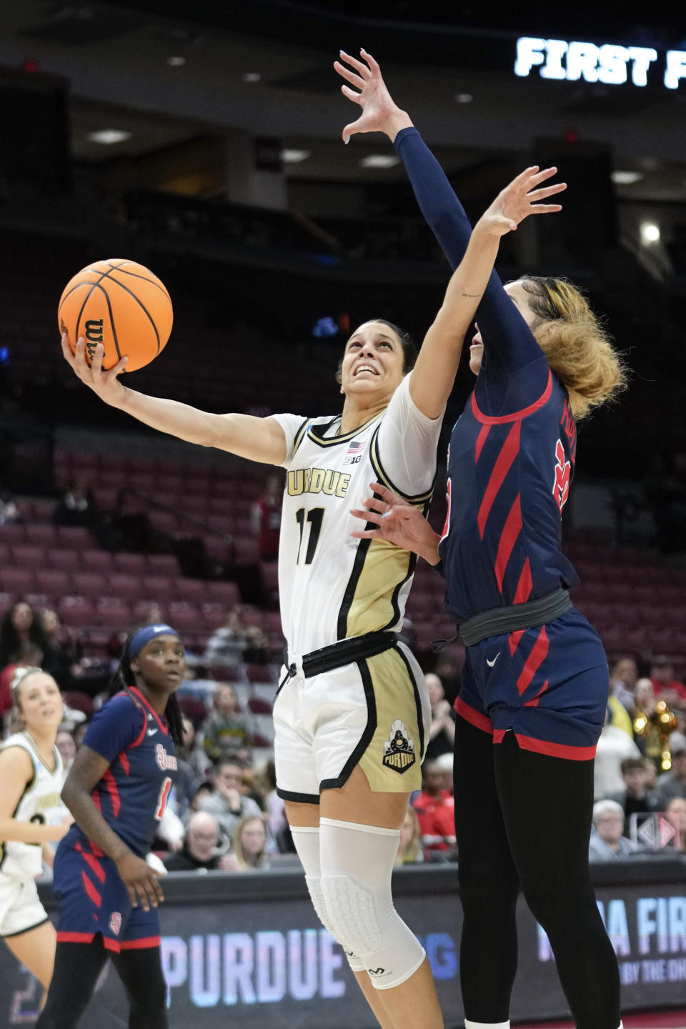 Purdue guard Lasha Petree (11) drives on St. John's forward Rayven Peeples (20) in the second half of a First Four women's college basketball game in the NCAA Tournament Thursday, March 16, 2023, in Columbus, Ohio. St. John's won 66-64. (AP Photo/Paul Sancya)