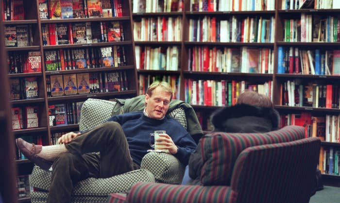A man relaxing and chatting with someone while sitting in an old chair in Barnes & Noble