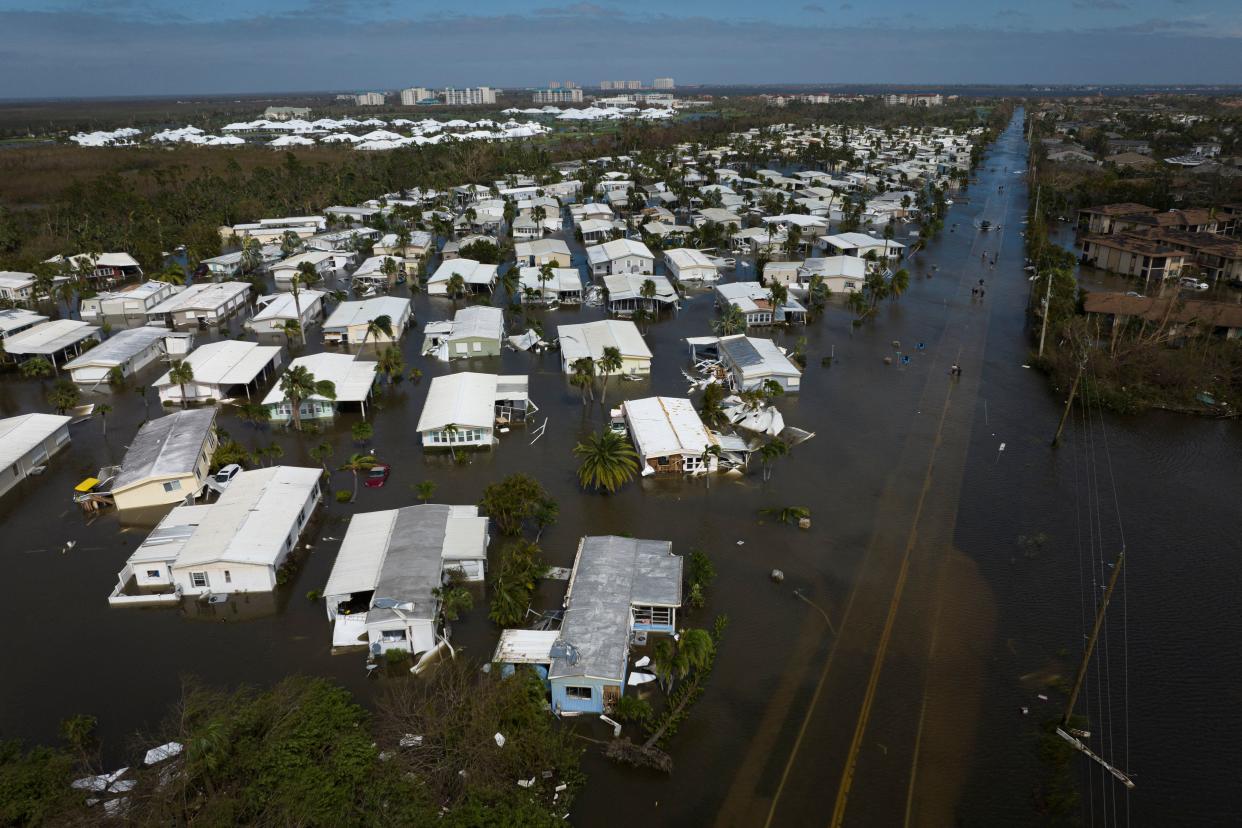 A neighborhood of flooded ranch houses stretching to the horizon.