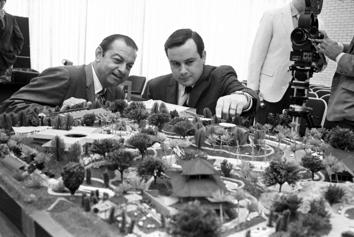 April 19, 1970: Arlington Mayor Tom J. Vandergriff, left, and Mike Jenkins, vice president of Six Flags Inc., examine a model of the proposed oceanarium, called the Seven Seas, which would be constructed near Turnpike Stadium by the city of Arlington. Six Flags Inc. would operate the second theme park.