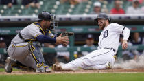 Detroit Tigers' Robbie Grossman, right, slides safely into home plate to score as Milwaukee Brewers catcher Omar Narvaez waits for the throw in the fourth inning of a baseball game in Detroit, Wednesday, Sept. 15, 2021. (AP Photo/Paul Sancya)