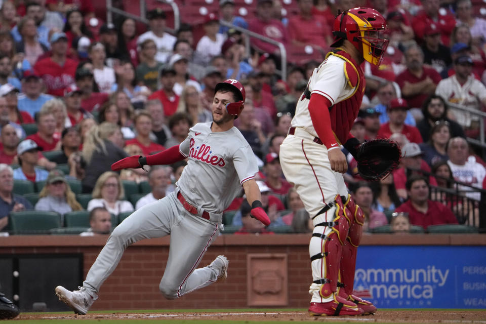 Philadelphia Phillies' Trea Turner, left, scores past St. Louis Cardinals catcher Willson Contreras during the first inning of a baseball game Saturday, Sept. 16, 2023, in St. Louis. (AP Photo/Jeff Roberson)