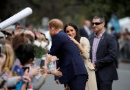 <p>Two girls in the crowd, Stephanie and Morgan, even decided they would help the couple with baby name suggestions, even handing Meghan a book with some ideas. Photo: Getty </p>