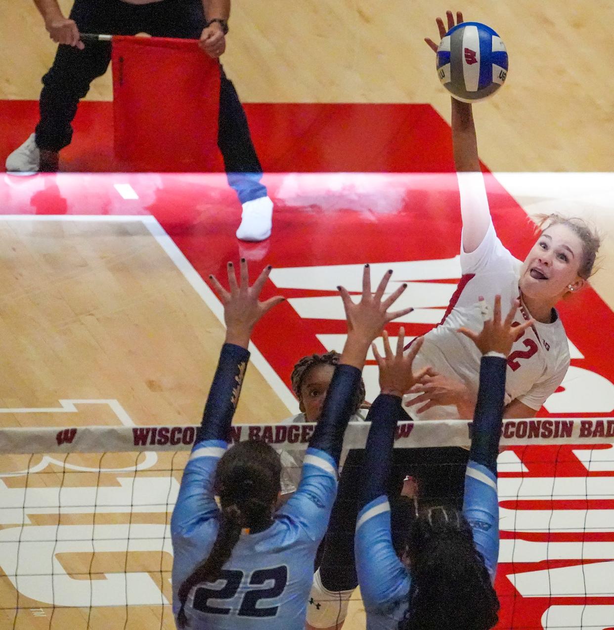 Marquette's Hattie Bray (22) plays defense as Wisconsin's Julia Orzol (22) spikes the ball during the third set of the season opener match Friday, Sept. 2, 2022, at Wisconsin Field House in Madison.