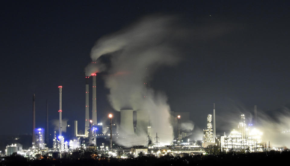 A Uniper coal-fired power plant and a BP oil refinery and chemical plant are at work in Gelsenkirchen, Germany, on Wednesday evening, Dec. 4, 2019. The UN Climate Change Conference COP 25 takes place in Madrid until Dec. 13, 2019, under the Presidency of the Government of Chile with logistical support from the Government of Spain. (AP Photo/Martin Meissner)