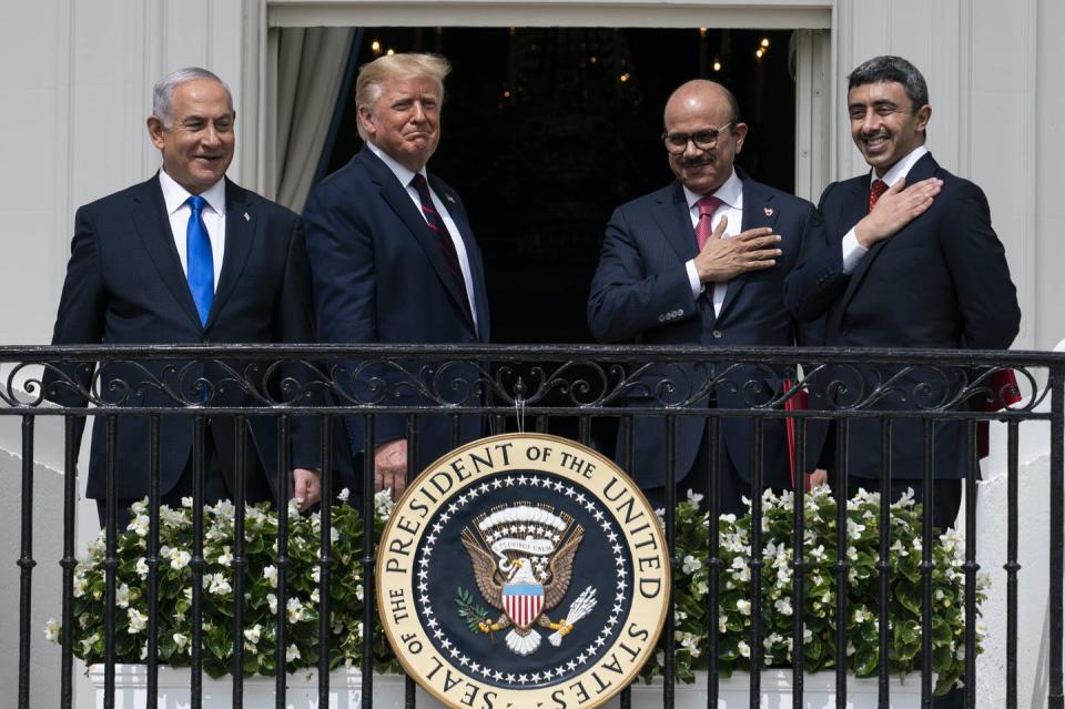 Israeli Prime Minister Benjamin Netanyahu, left, President Donald Trump, Bahrain Foreign Minister Khalid bin Ahmed Al Khalifa and United Arab Emirates Foreign Minister Abdullah bin Zayed al-Nahyan stand together on a balcony.