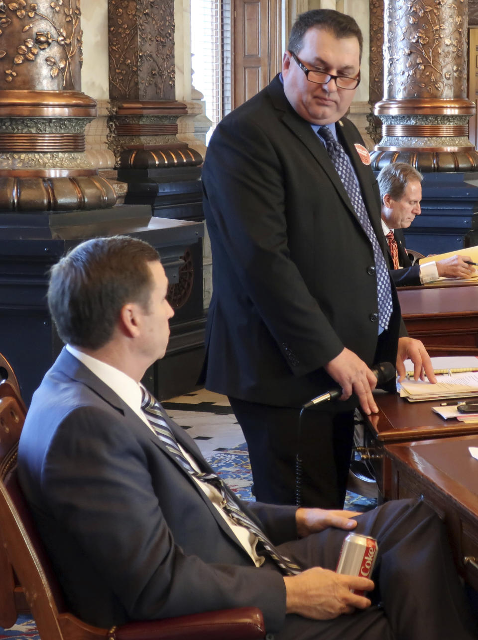 In this Wednesday, Feb. 20, 2019 photo, Kansas state Sen. Rob Olson, right, R-Olathe, confers with Sen. Dennis Pyle, left, R-Hiawatha, during a debate on a bill allowing the Kansas Farm Bureau to offer health coverage to its members, at the Statehouse in Topeka, Kan. Olson is chairman of a committee that endorsed the bill and Pyle supports it. (AP Photo/John Hanna)