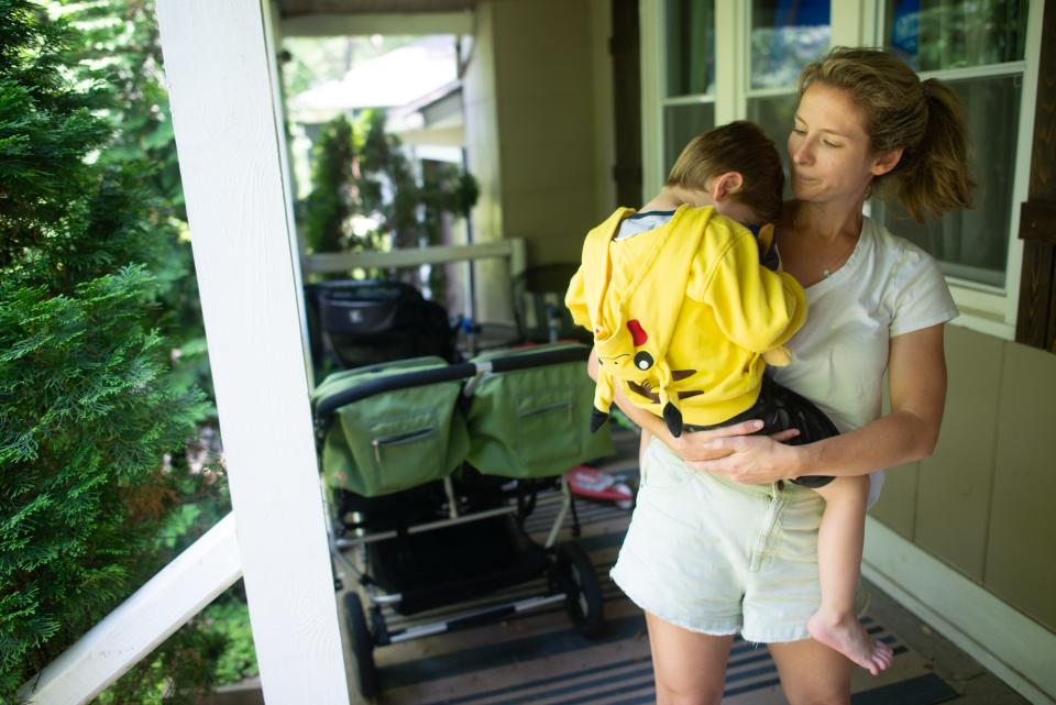 Laura Robertson holds her son Theo, 4, while talking about how the anti-abortion amendment to the Kansas Constitution and recent overturning of Roe v. Wade has given her an increased sense of anxiety.