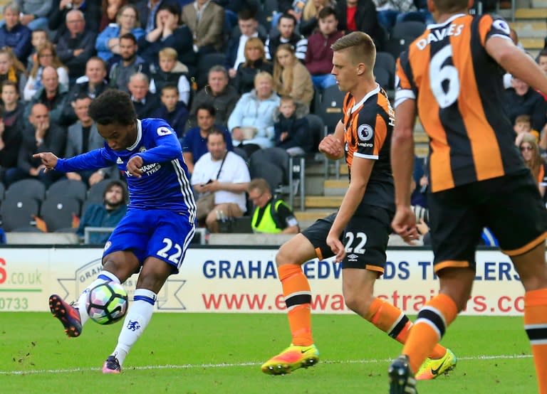 Chelsea's Brazilian midfielder Willian (L) shoots to score the opening goal against Hull City during an English Premier League football match in Kingston upon Hull, north east England on October 1, 2016