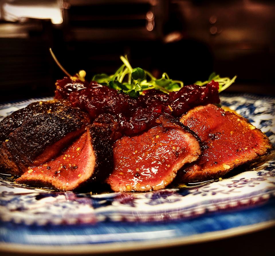 Porcini mushroom flour dusted venison with citrus cranberry relish, fork-mashed gold potatoes, parsley gremolata and roasted heirloom carrots.