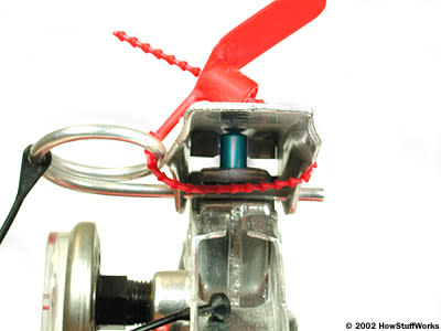 <b>The operating lever pushes down on an actuating rod (the blue piece).</b>