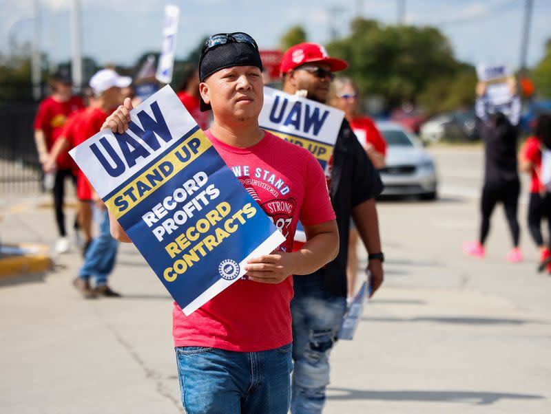 Trabajadores en huelga del sindicato United Auto Workers caminan frente a la planta de ensamblaje de Ford en Michigan, EEUU