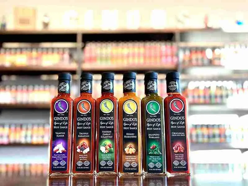Gindo's Hot Sauce flavors lined in a row, courtesy of Gindo's Spice of Life in St. Charles, Illinois.