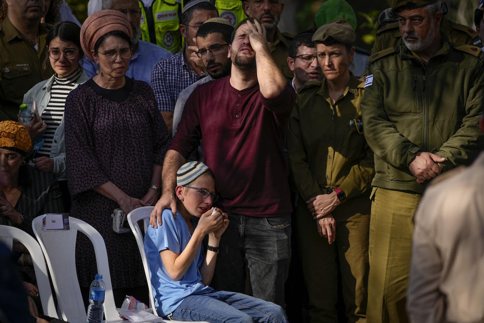 Mourners react during the funeral of Hillel Yaniv, 21, and Yagel Yaniv, 19, at Israel's national cemetery in Jerusalem, Monday, Feb. 27, 2023. The two Israeli brothers were killed Sunday in the West Bank town of Hawara by a Palestinian gunman who fled the scene. (AP Photo/Ohad Zwigenberg)