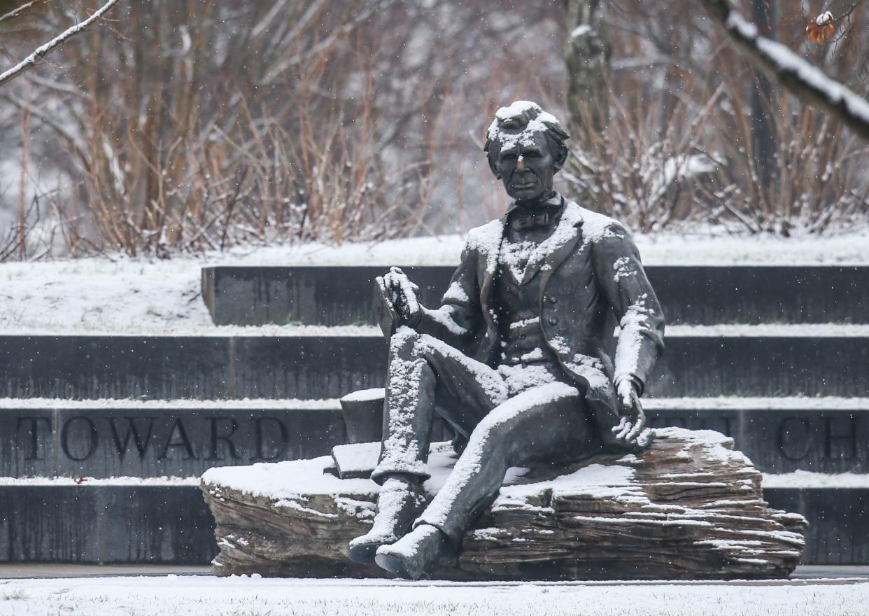 Abraham Lincoln is dusted with snow at Waterfront Park Friday morning. Snow showers are expected  throughout the afternoon. January 28, 2022