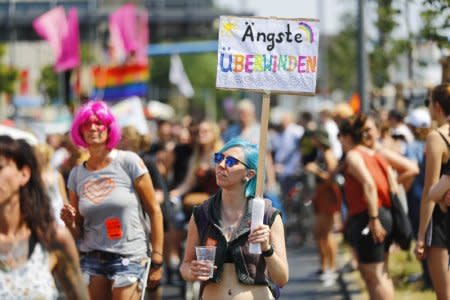 People stage a protest against Anti-immigration party Alternative for Germany (AfD) in Berlin, Germany May 27, 2018. Sign reads