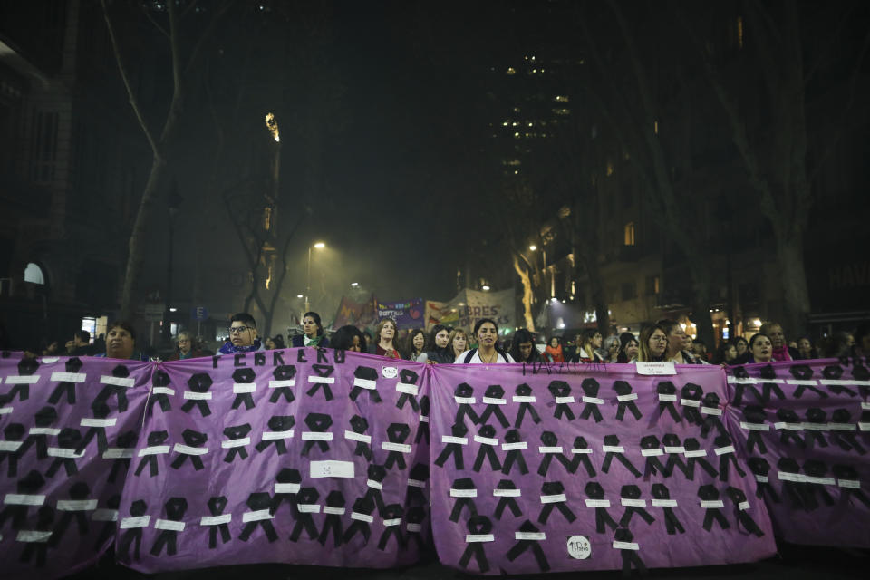 Women hold a banner covered in black ribbons representing murdered women as they protest against gender violence in Buenos Aires, Argentina, Monday, June 3, 2019. The grassroots movement "Ni una menos," or Not One Less, is marking its fourth anniversary by remembering the hundreds of women who have been murdered since its founding, and demanding laws to curb gender based violence that continues to permeate Argentine society. (AP Photo/Natacha Pisarenko)