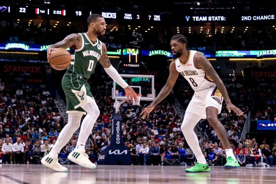 Bucks guard Damian Lillard looks for a way around Pelicans forward Naji Marshall in the first half Thursday night.