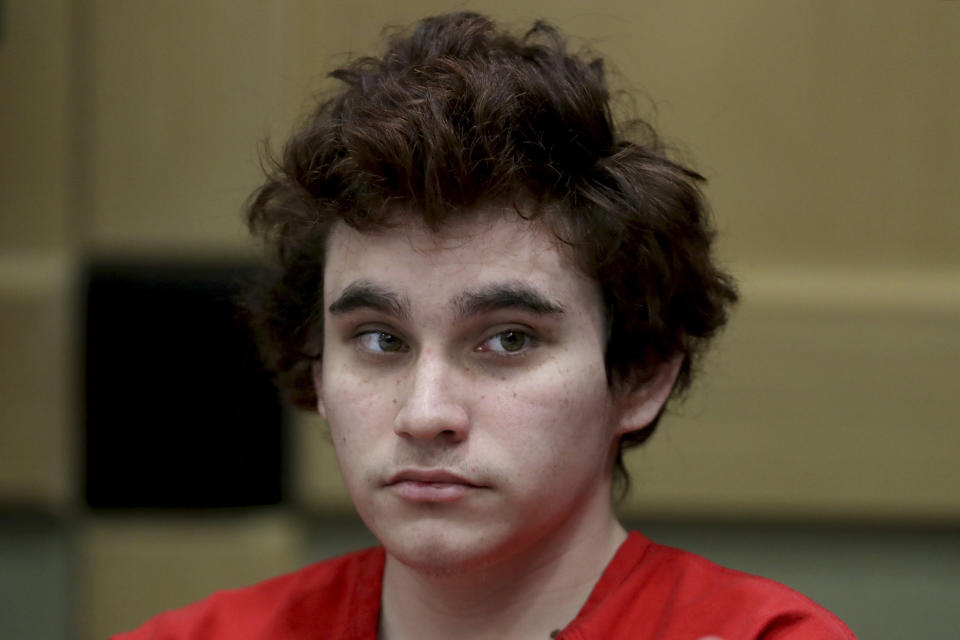 FILE - In this Tuesday, Nov. 27, 2018, file photo, Florida school shooting suspect Nikolas Cruz sits in the courtroom for issues dealing with procedural motions at the Broward Courthouse in Fort Lauderdale, Fla. A status hearing is set for Tuesday, Jan. 8, 2019, for Cruz in the Florida school massacre that killed 17 people in 2018. (Amy Beth Bennett/South Florida Sun-Sentinel via AP, Pool, File)