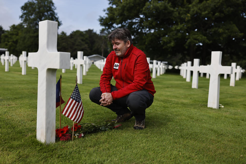 The Associated Press Correspondent John Laicester pays tribute to Associated Press photographer Bede Irvin at the Normandy American Cemetery in Colleville-sur-Mer, France on Monday, June 3, 2024. Bede Irvin was killed July 25, 1944 near the Normandy town of Saint-Lo as he was photographing an Allied bombardment. (AP Photo/Jeremias Gonzalez)