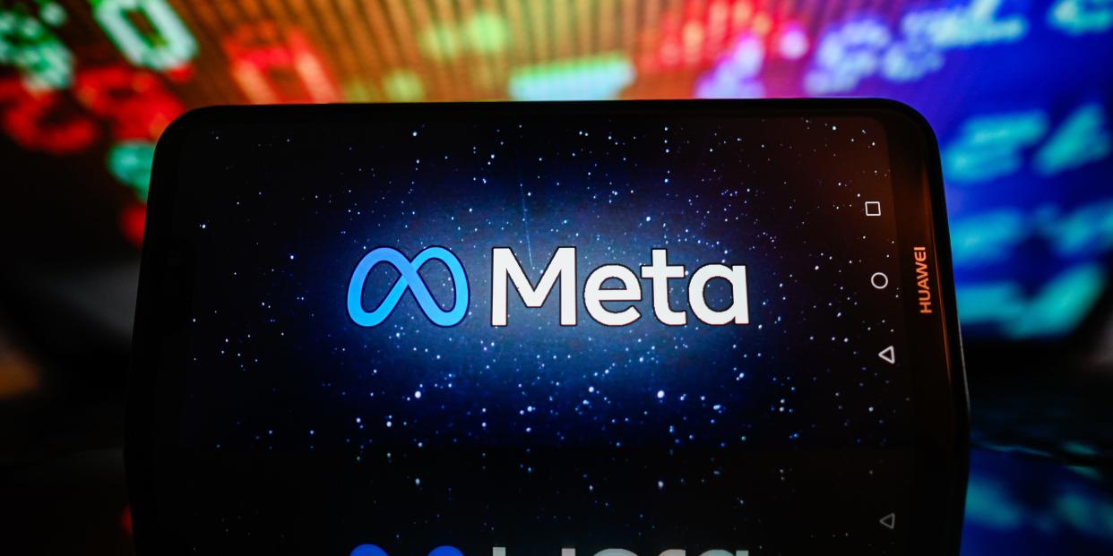 In this photo illustration, a Meta logo is displayed on a smartphone with stock market percentages in the background.