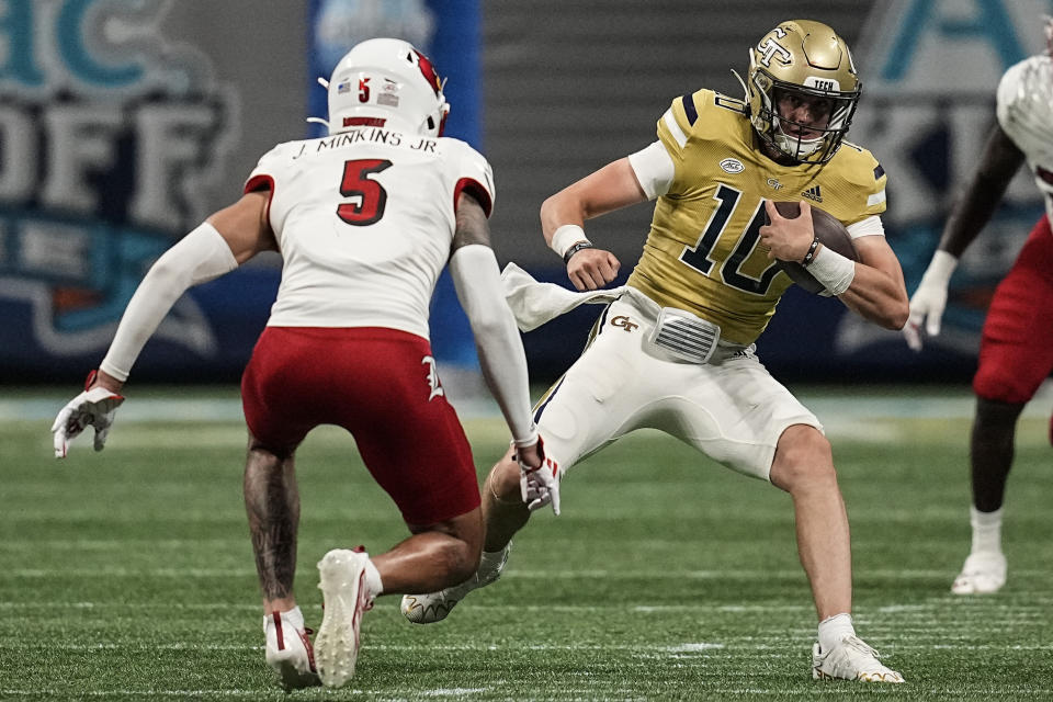 Georgia Tech quarterback Haynes King (10) runs against Louisville defensive back Josh Minkins (5) during the first half of an NCAA college football game, Friday, Sept. 1, 2023, in Atlanta. (AP Photo/Mike Stewart)